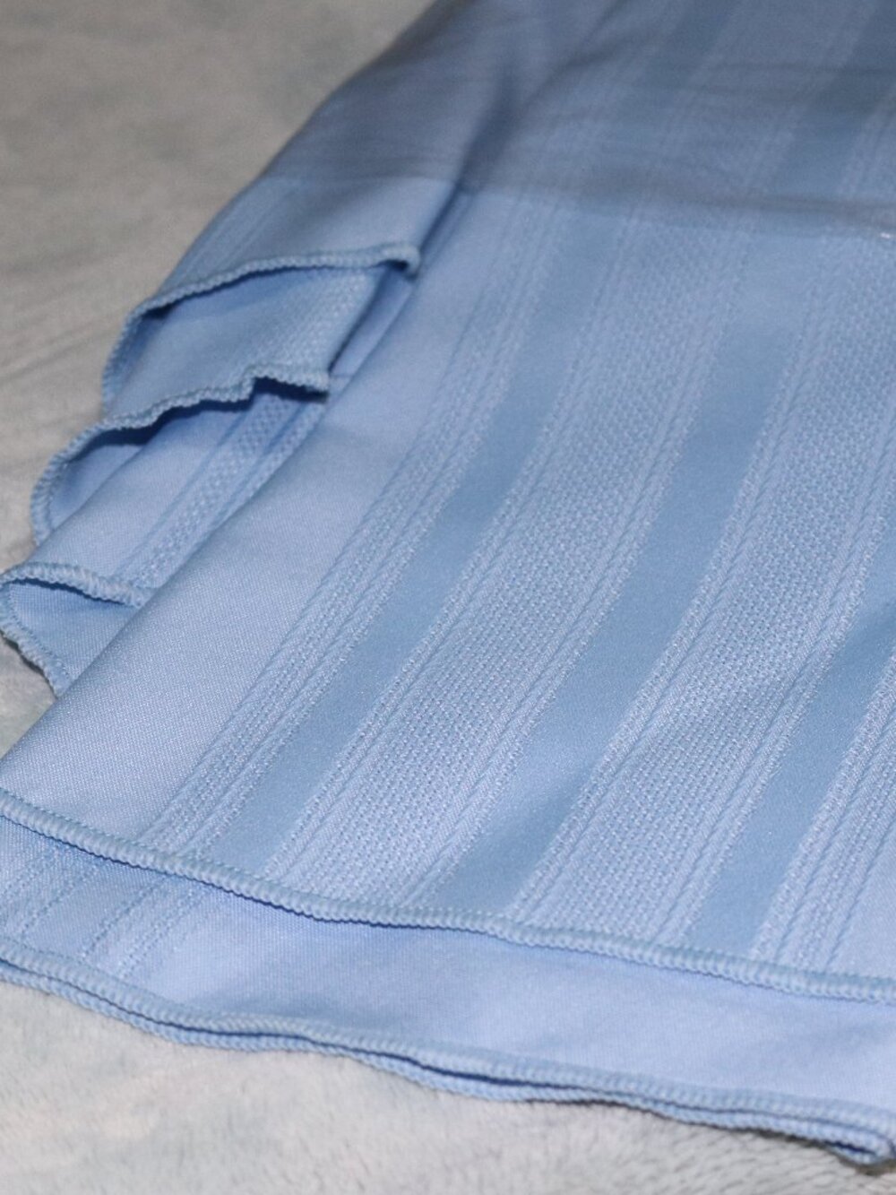 Light blue circular tablecloth. 5 x 7.